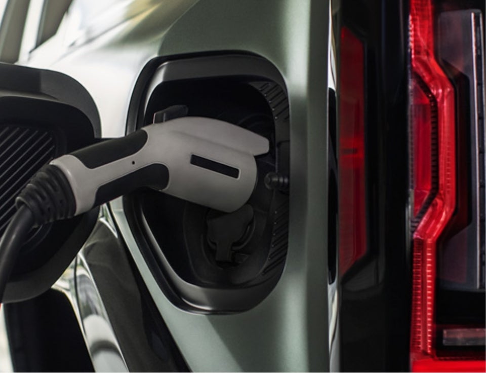 Close up of charging port with charger plugged in on a GMC Hummer EV SUV - Country Club Motors GMC in Oneonta NY